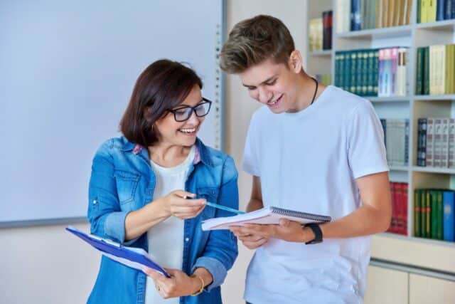 Image of female teacher helping male student study